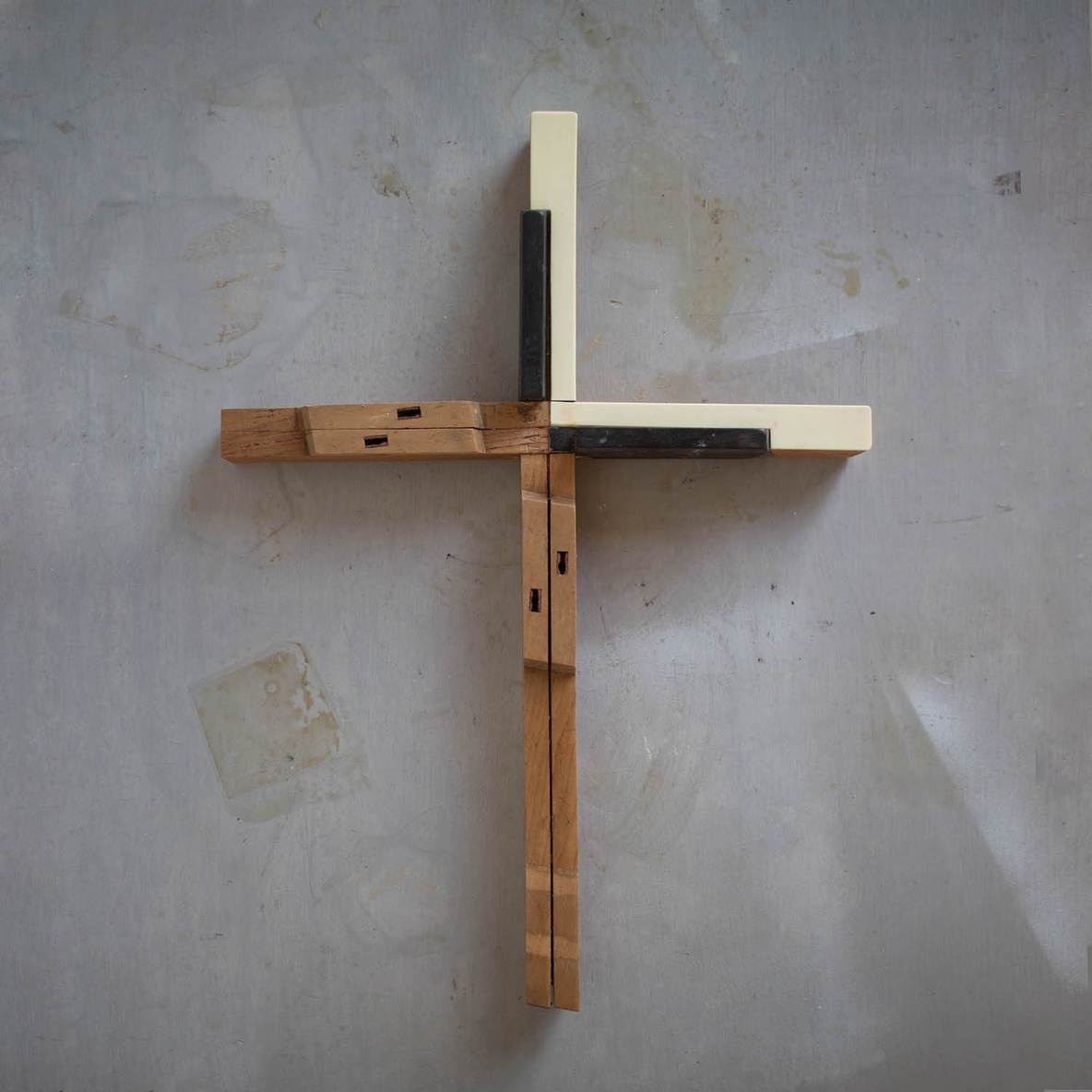 Wooden piano key cross by Dennehey Design Co. featuring a cross shape crafted from piano keys, suitable for music-themed decor.