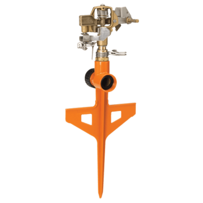 Orange Dramm ColorStorm Impulse Circular Stake Sprinkler set up outdoors, showing its orange stake and spray pattern for watering gardens.