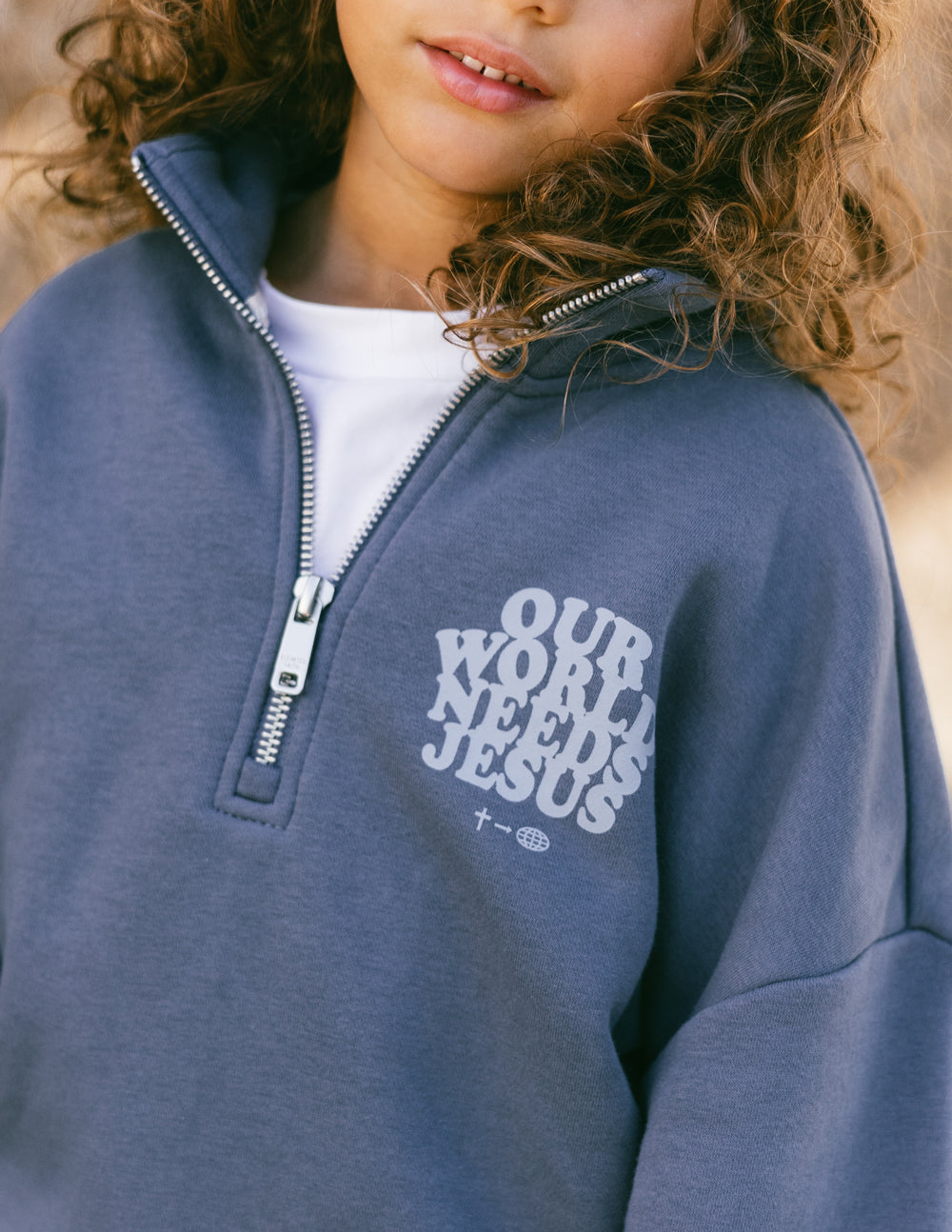 Our World Needs Jesus Kids Half-Zip - Blessings Grow Meadows