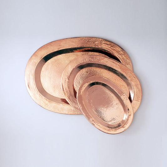 Sertodo Thessaly oval copper platter set with polished, hammered finish, ideal for serving food in a stylish presentation.
