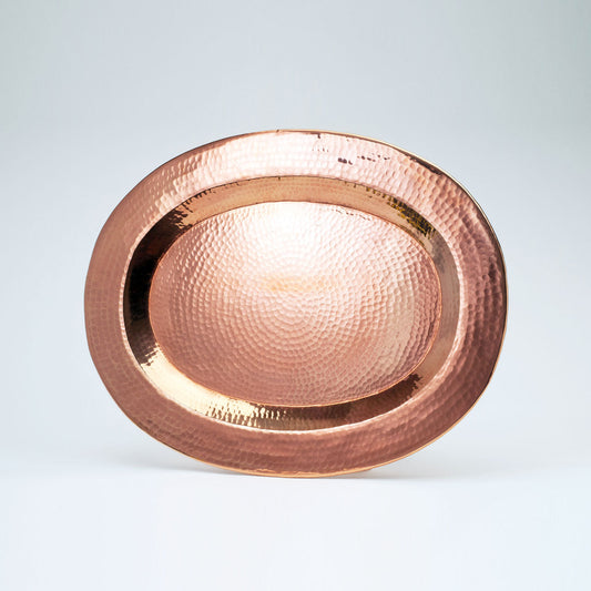 Medium Thessaly oval copper platter by Sertodo, featuring a smooth, shiny copper surface with rounded edges for serving.