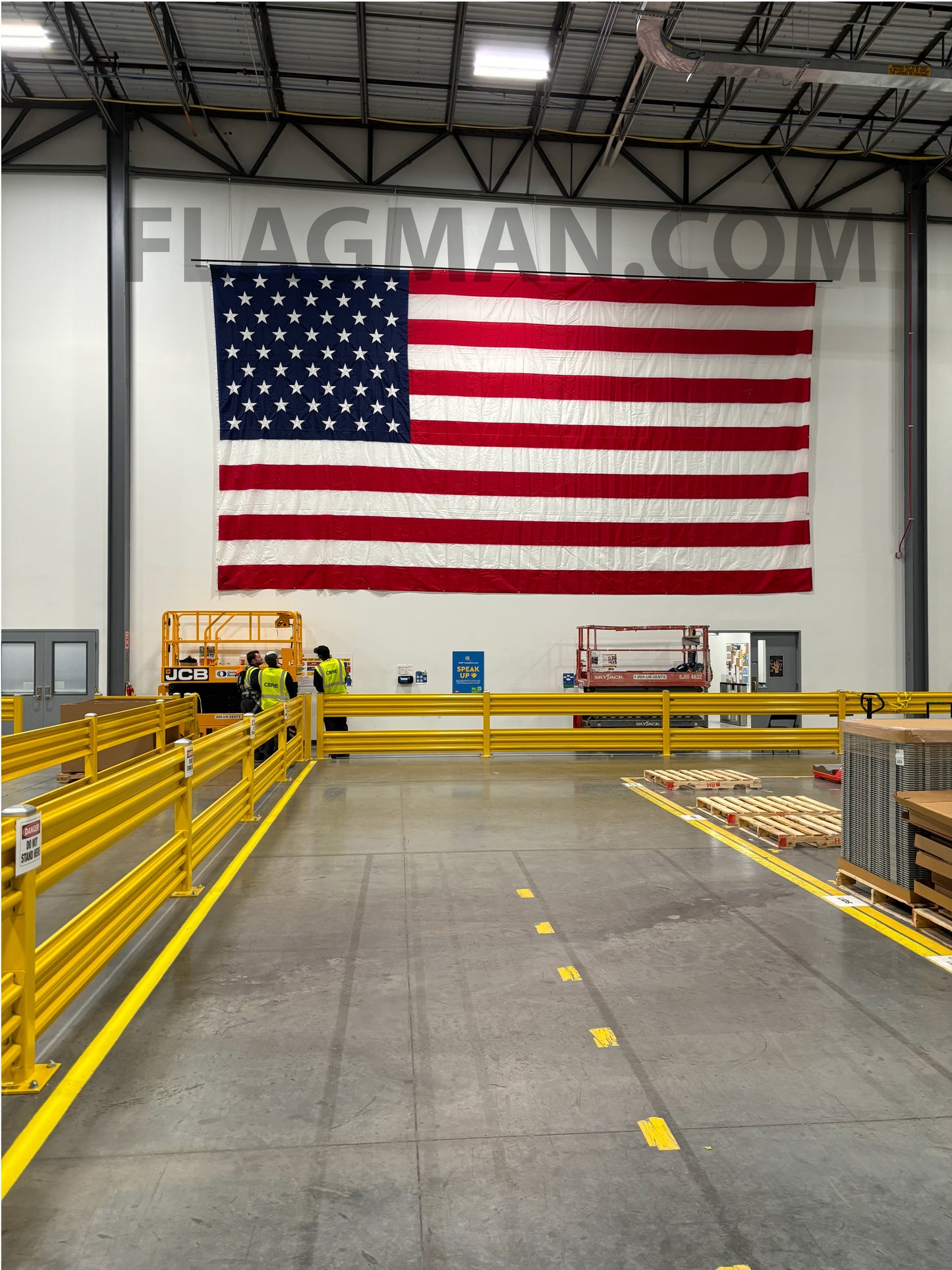 WallSafe™ polyester wall-mounted American flag with reinforced edge grommets, featuring vibrant stars and stripes, made in the USA.