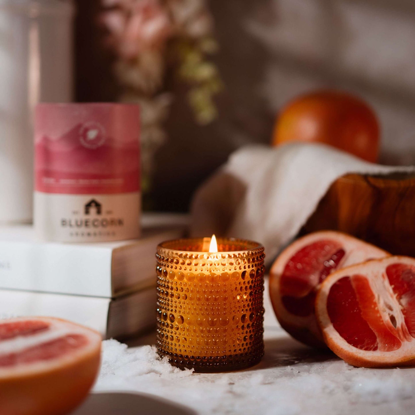 Bluecorn Candles Paloma scented candle in glassware with grapefruit aroma, perfect for creating a relaxing atmosphere.