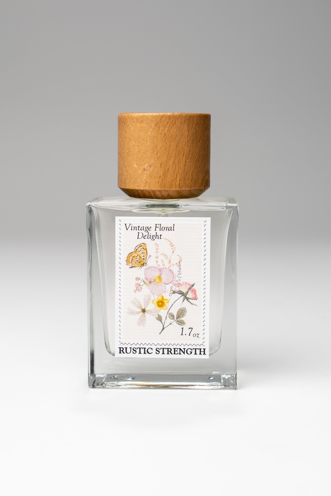 Rustic Strength Vintage Floral Delight perfume bottle, 1.7oz with floral label and elegant design on a white background.