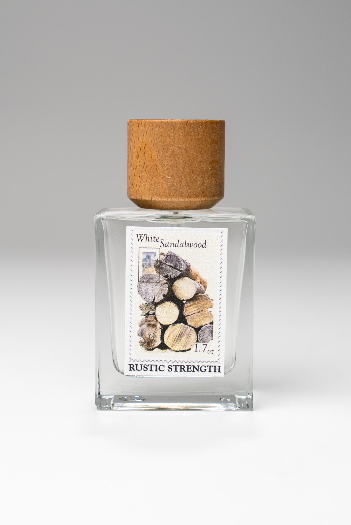 Rustic Strength White Sandalwood perfume bottle, 1.7oz, with elegant packaging and a fresh sandalwood scent.