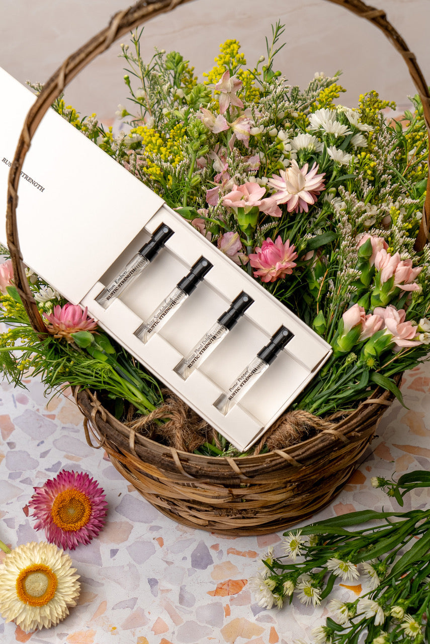 Rustic Strength perfume sample pack with four different scent vials arranged in a sleek display.