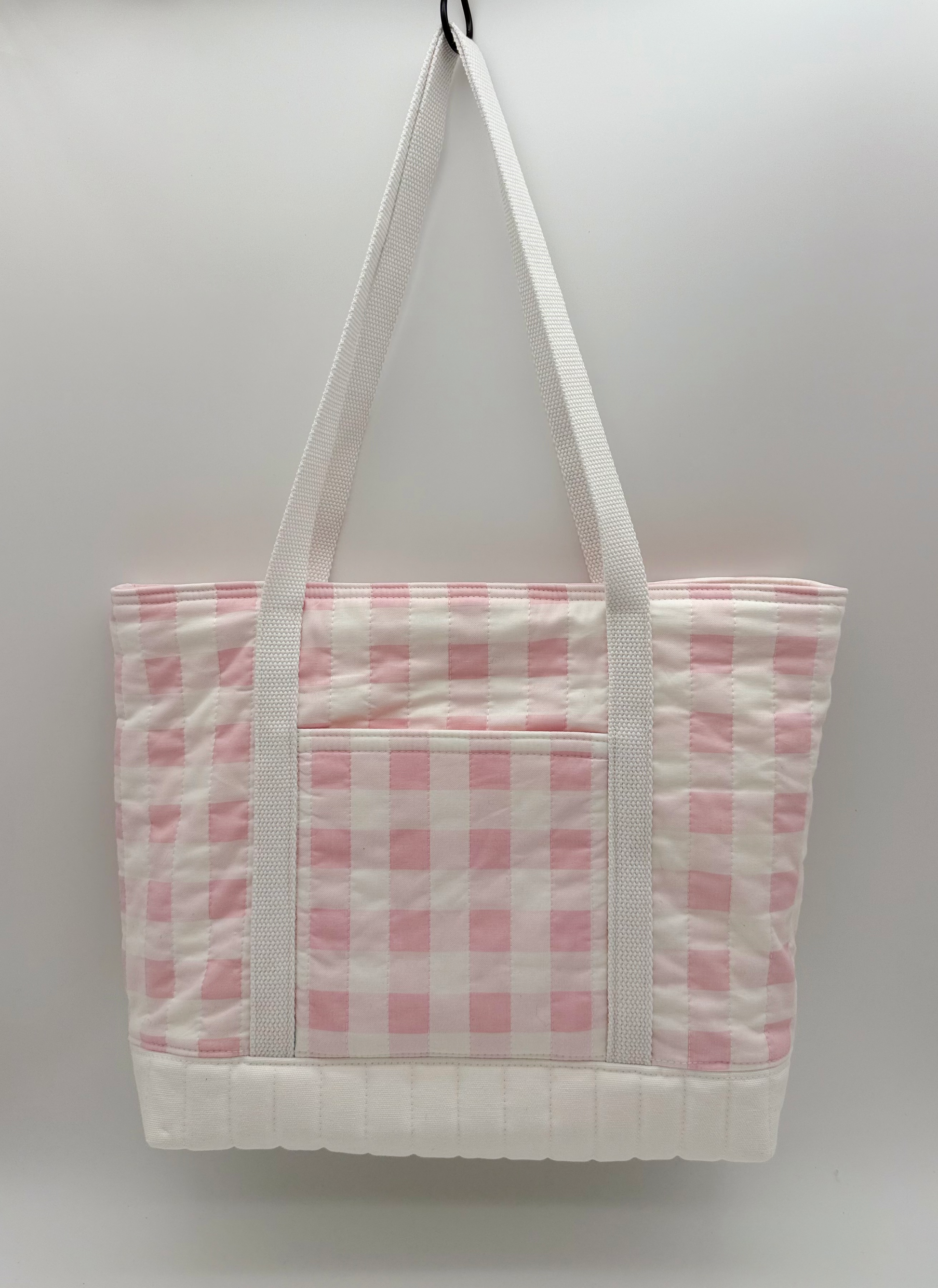 Pink gingham quilted tote bag with snap closure, handmade canvas design, shown from the back.