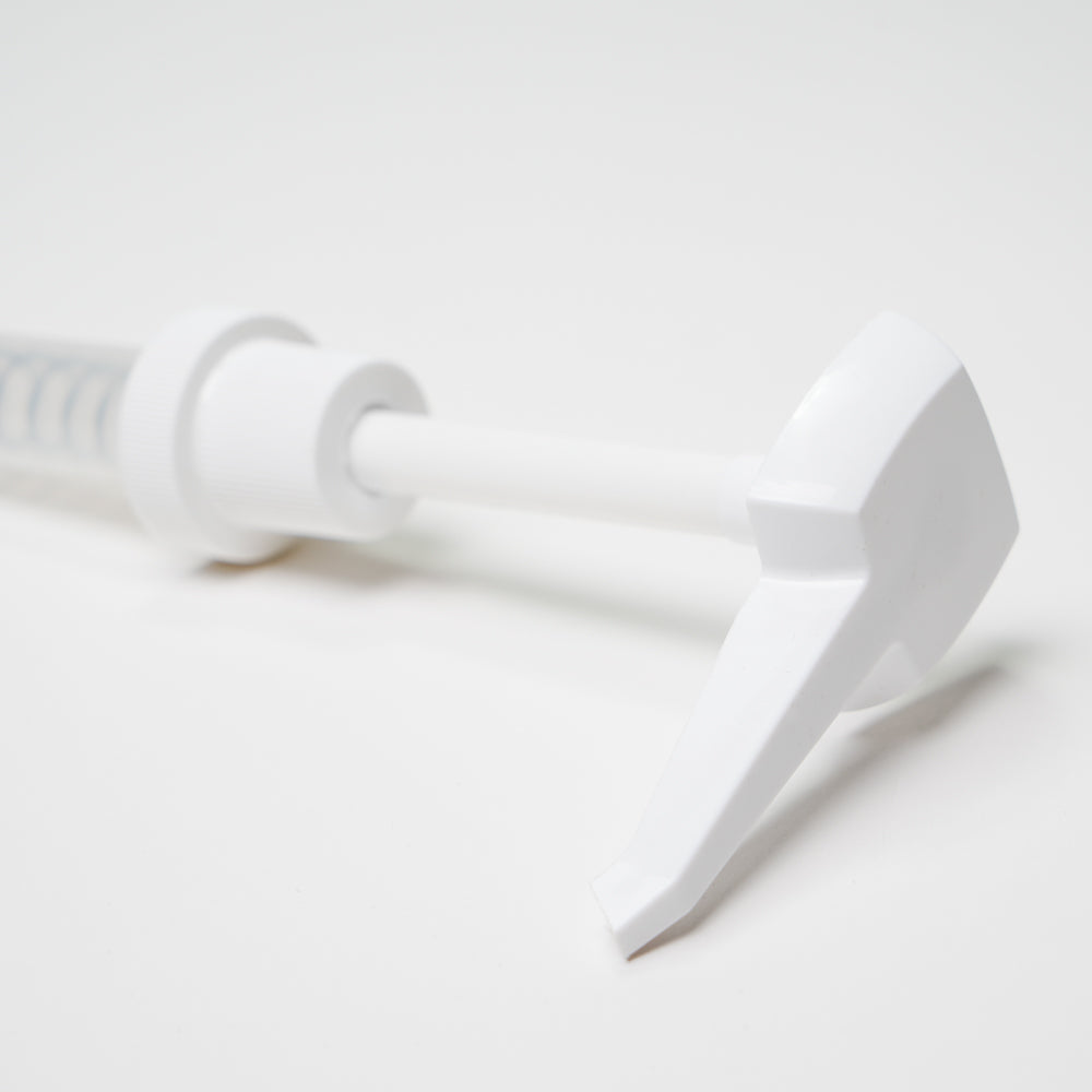 Close-up of the Rustic Strength 1 Gallon Jug Measuring Pump, a white plastic dispenser perfect for use with 1-gallon jugs and designed to help reduce waste.