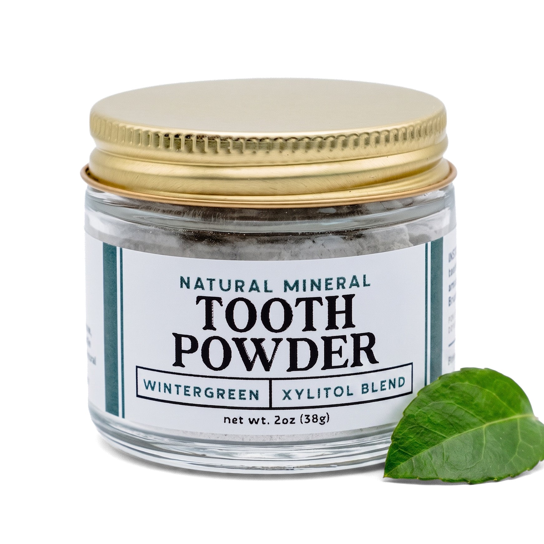 Remineralizing tooth powder with hydroxyapatite and xylitol by Revive Homestead, featuring wintergreen flavor, in a resealable jar.