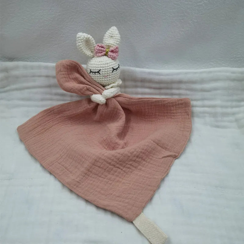 Baby bib with sleeping animal designs and attached rattle by Petite Pioneers, soft fabric, colorful and suitable for infants.