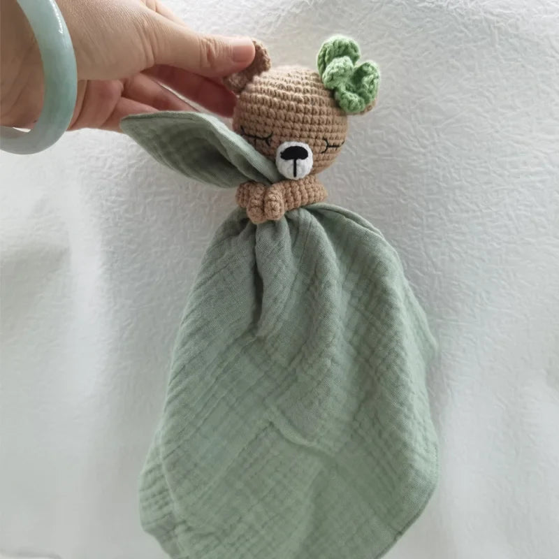 Soft baby bib with sleeping animal illustrations and attached rattle, ideal for gentle feeding and playtime.