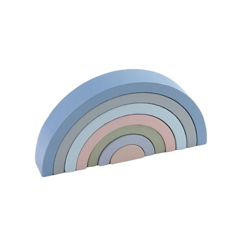 Small wooden rainbow arch blocks by Petite Pioneers, colorful stacking toys for children with vibrant rainbow shapes.