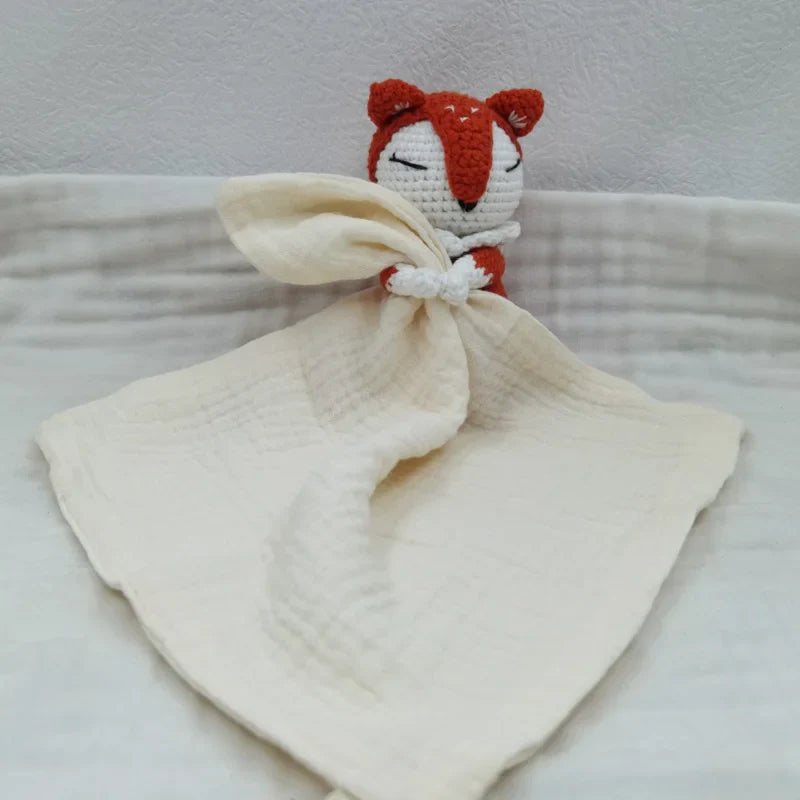 Baby bib with sleeping animals and rattle from Petite Pioneers, featuring soft fabric and colorful animal designs.