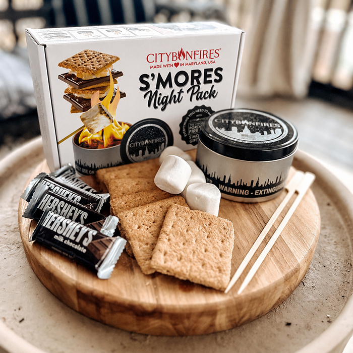 City Bonfires S'mores Night Pack outdoors set with marshmallows, chocolate, graham crackers, and camping accessories for outdoor fun.