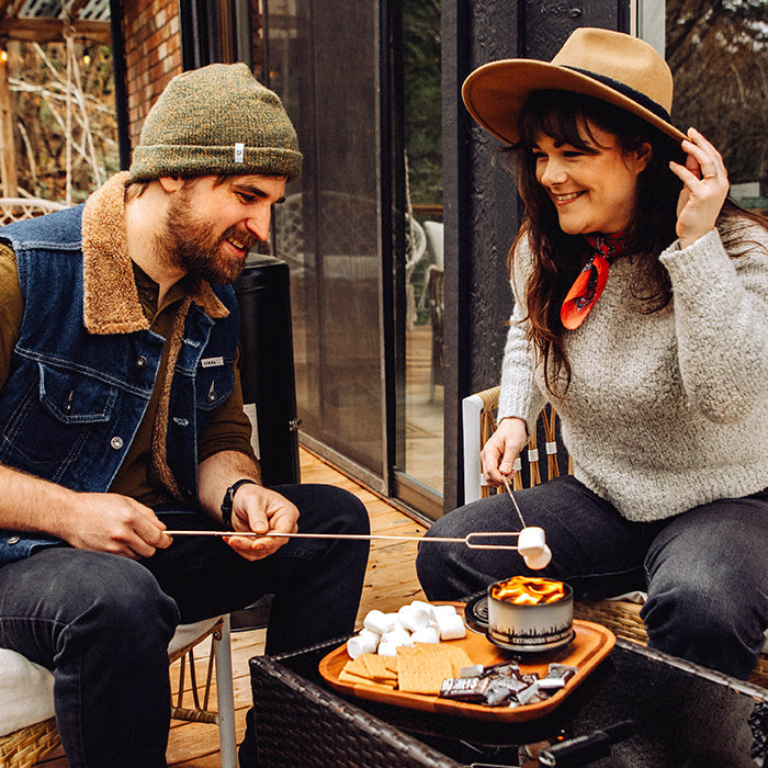 City Bonfires S'mores Night Pack outdoors set on a wooden deck with marshmallows, graham crackers, and chocolate for cozy outdoor s'mores.