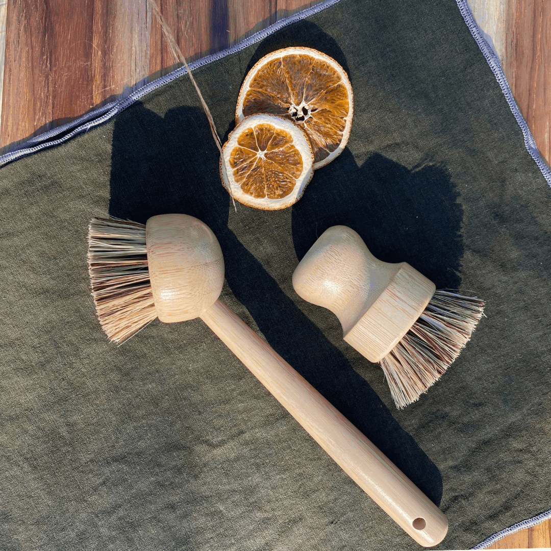 Tilley + Me eco-friendly bamboo dishwashing brush with handle and palm fiber bristles for gentle cleaning.