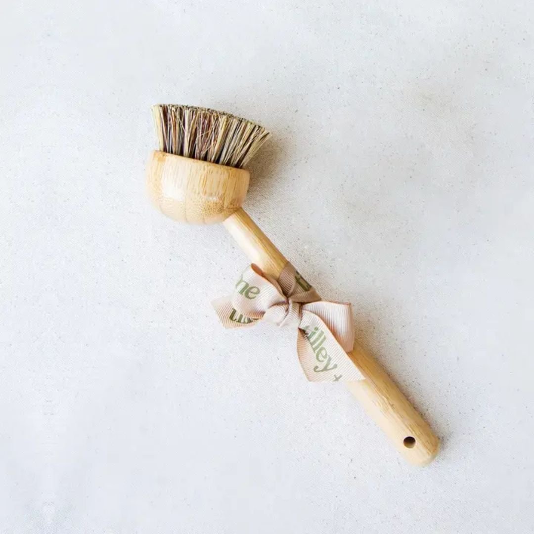 Tilley + Me eco-friendly bamboo dishwashing brush with handle and palm fiber bristles for gentle cleaning.