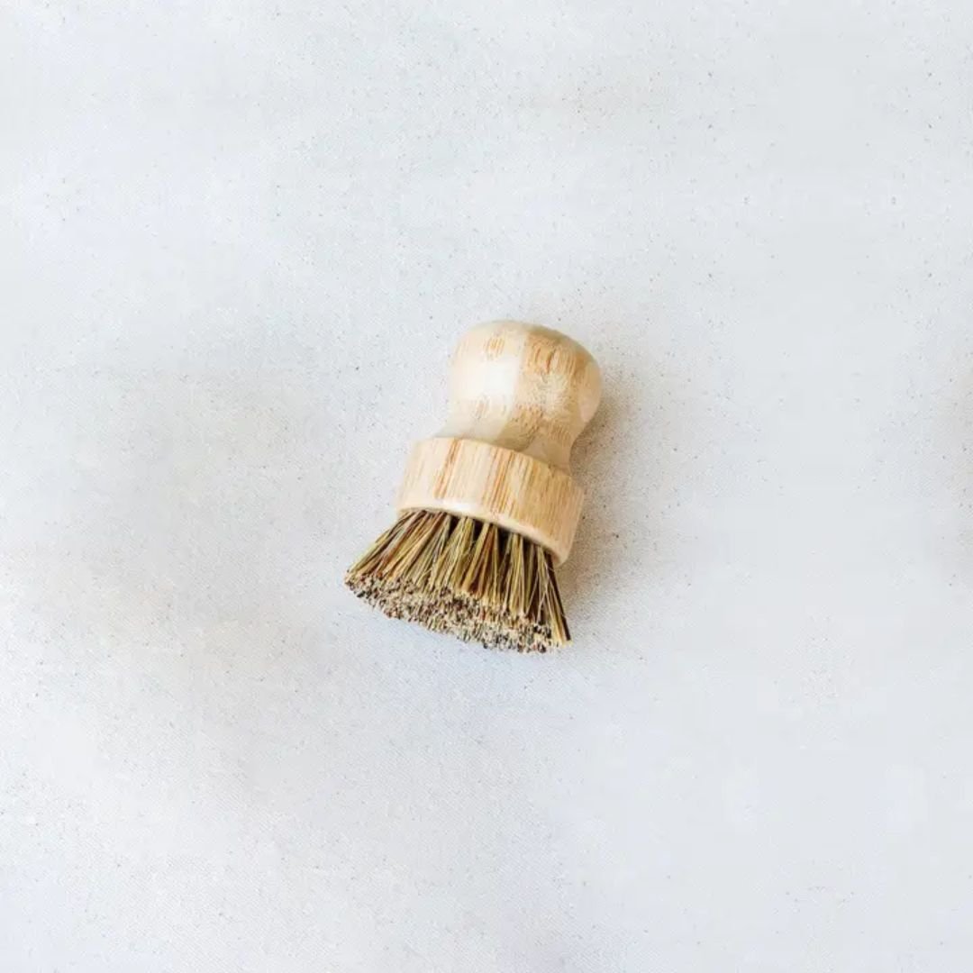 Tilley + Me sustainable bamboo pot scrubber with tough bristles, designed for cleaning cookware while being eco-friendly.
