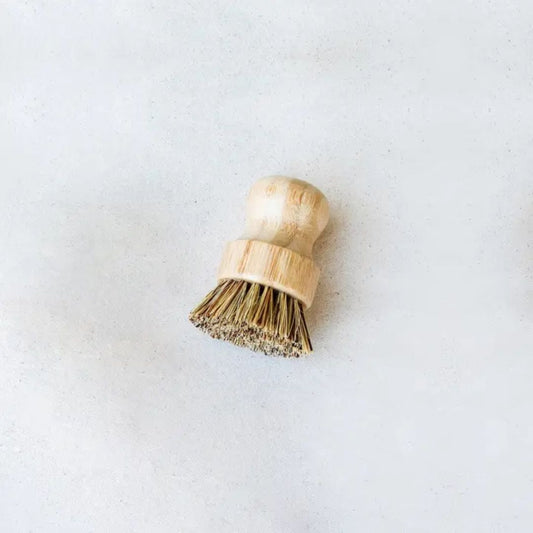 Tilley + Me sustainable bamboo pot scrubber with tough bristles, designed for cleaning cookware while being eco-friendly.
