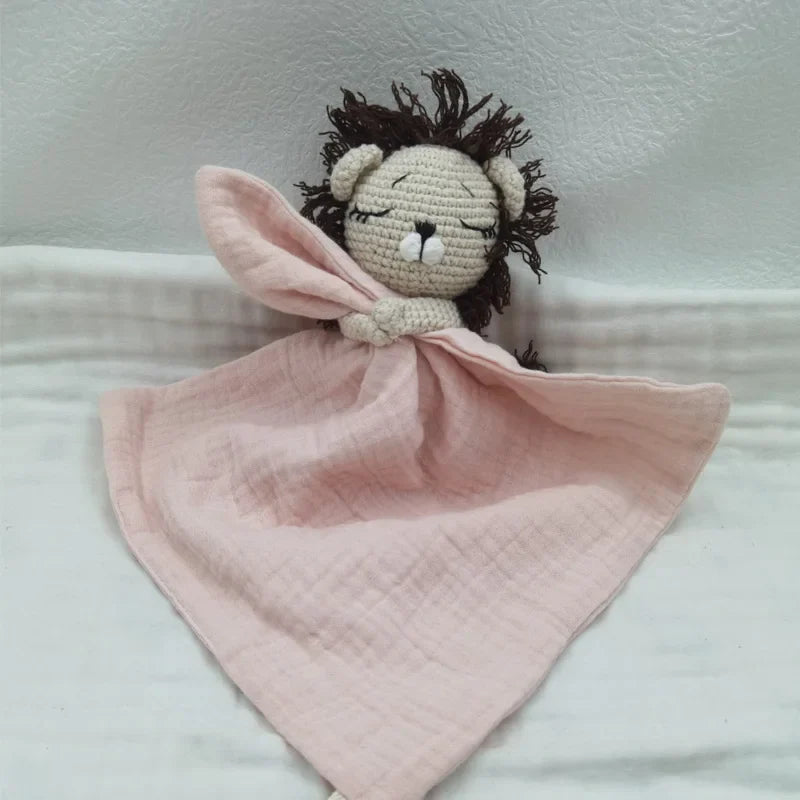 Baby bib with sleeping animal illustrations and attached rattle from Petite Pioneers, soft fabric and colorful design for infants.