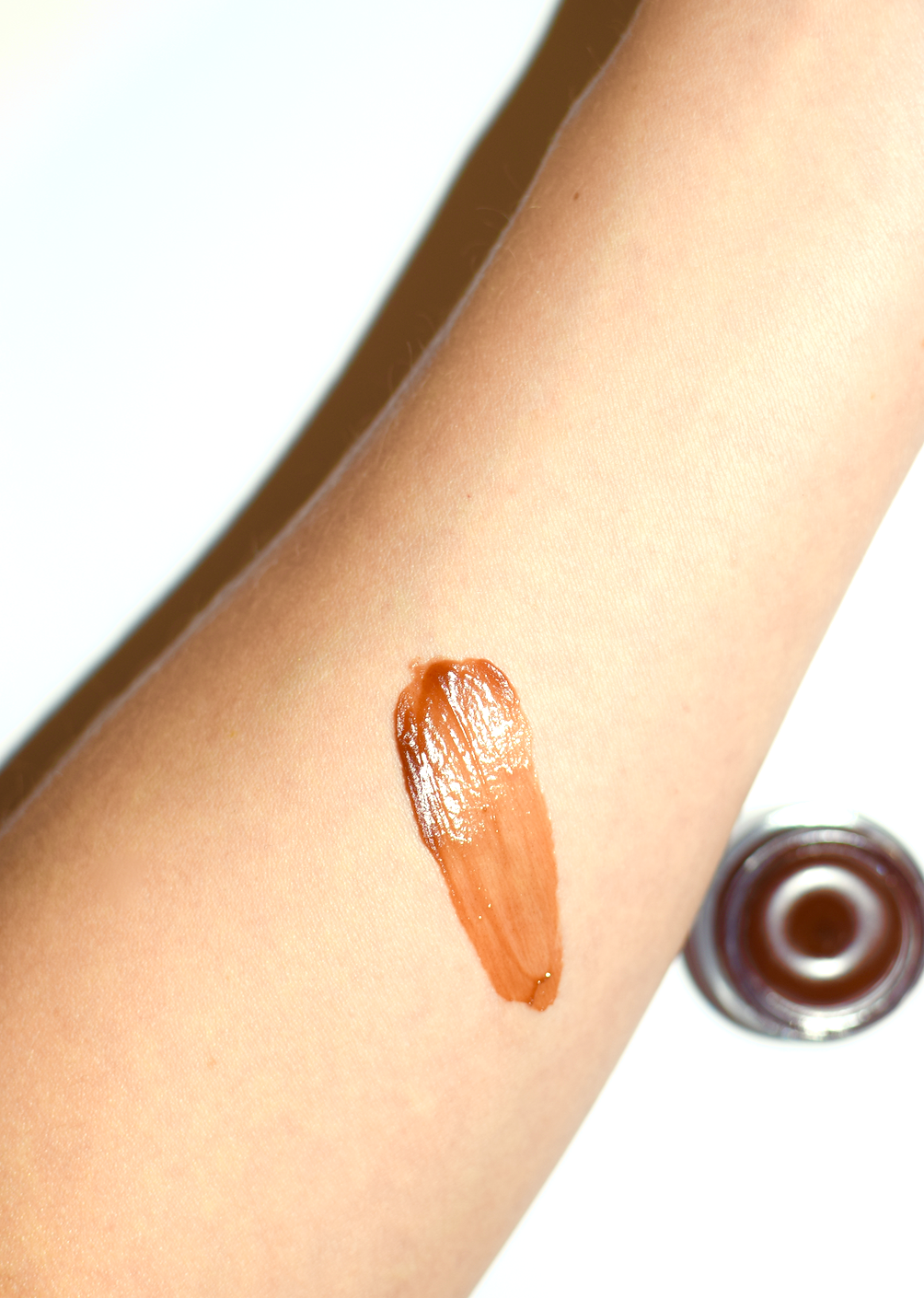 Plant Makeup Cocoa Lip Gloss applied on lips, showing glossy, smooth finish in a natural light.
