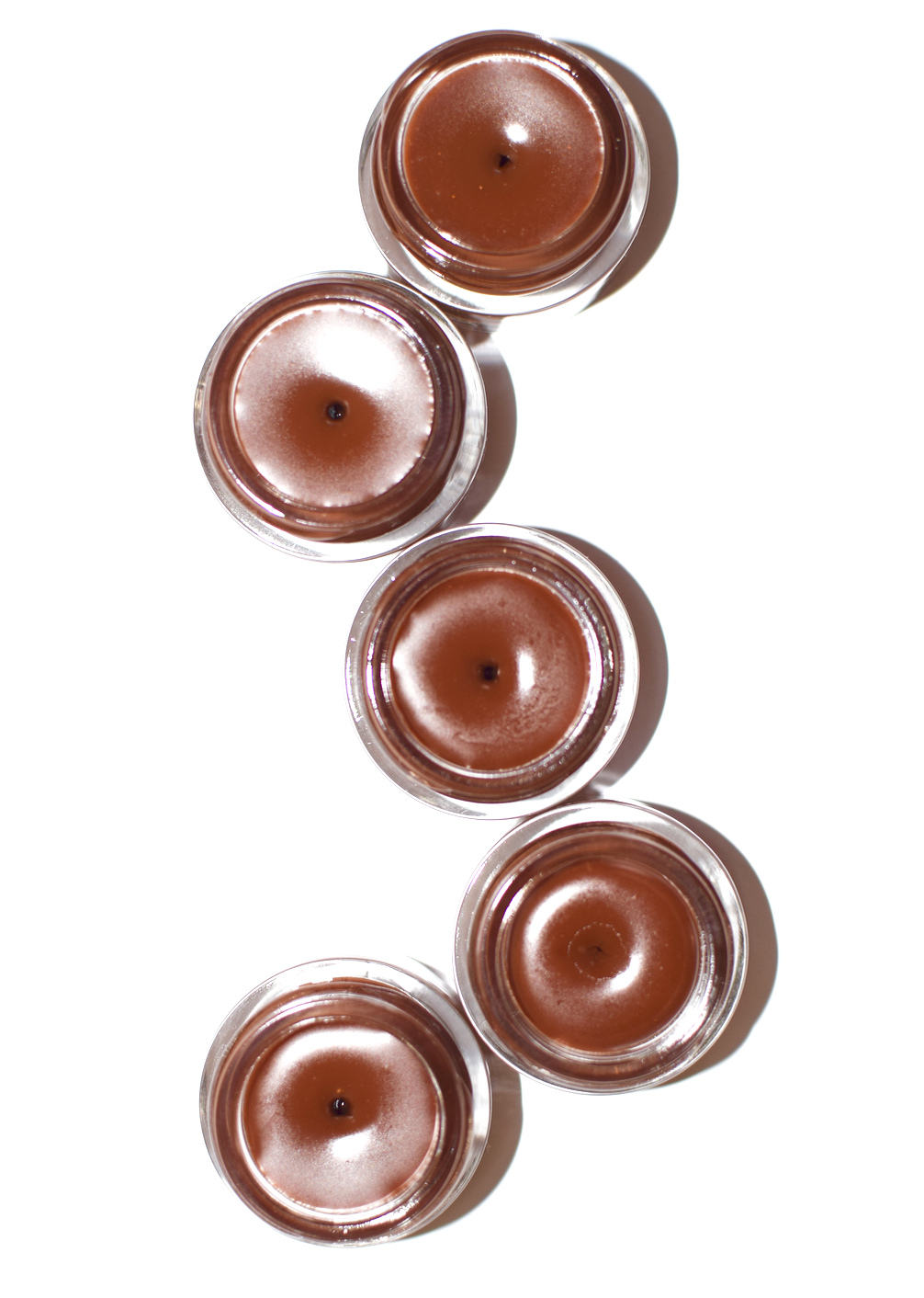 Close-up of Plant Makeup Cocoa Lip Gloss tube with clear packaging and applicator showing rich cocoa-colored lip gloss.