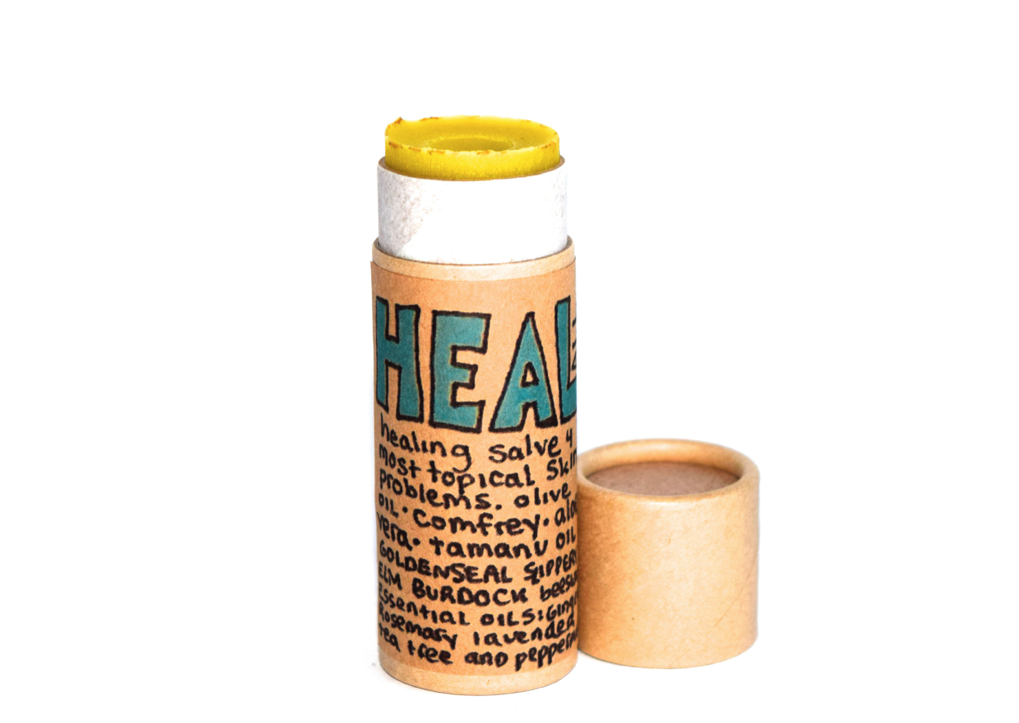 Close-up of Plant Makeup Heal All Balm jar with white label and black lid, showing the product container.