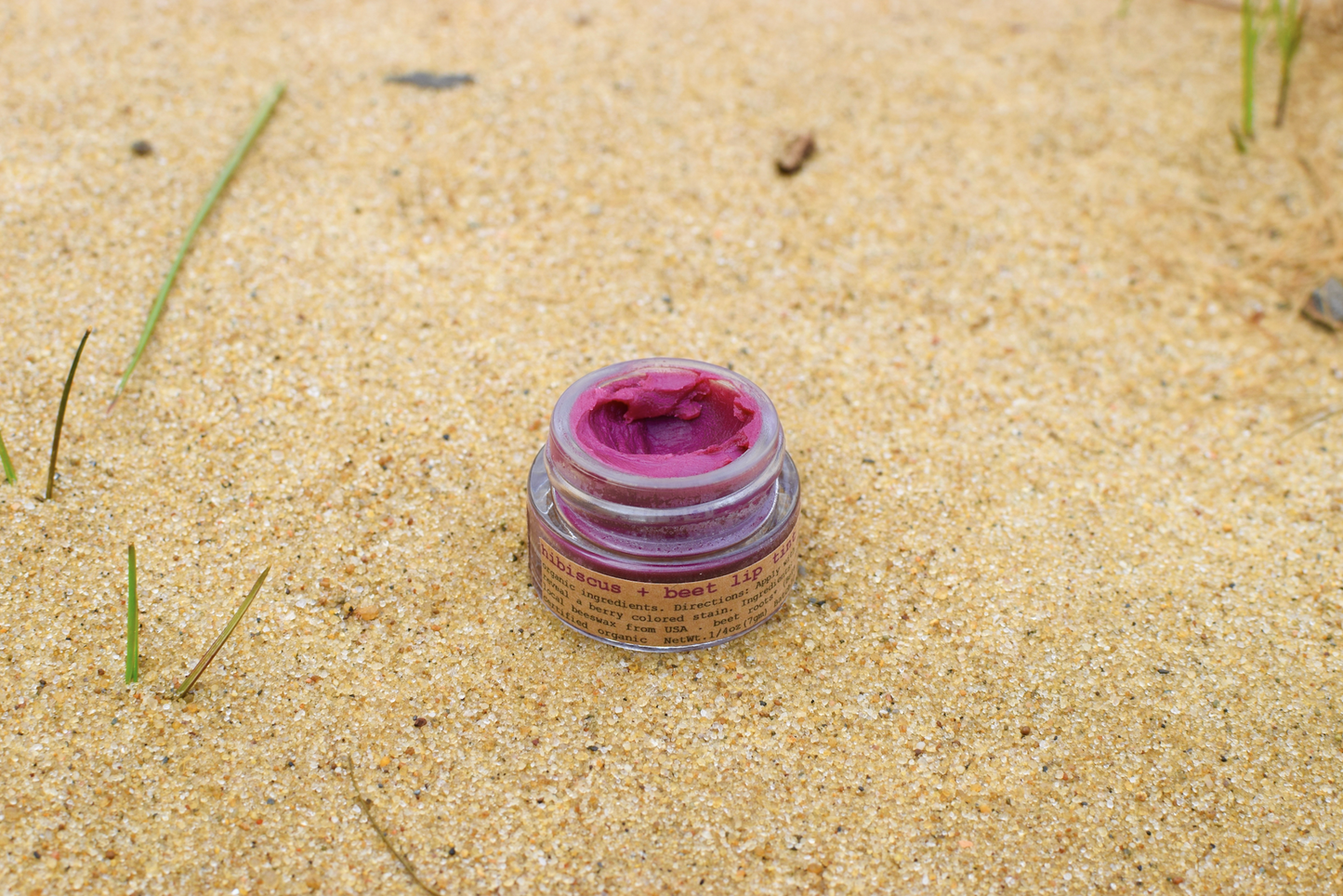 Plant Makeup Hibiscus and Beet Lip Tint in a sleek tube with vibrant pink and red shades, showcasing natural ingredients.