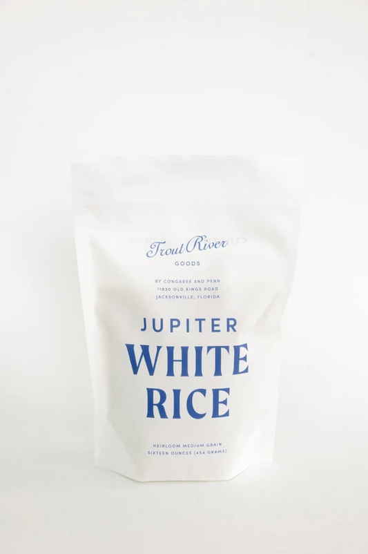 Congaree and Penn Jupiter White Rice grains, close-up view showing white rice in a transparent container.