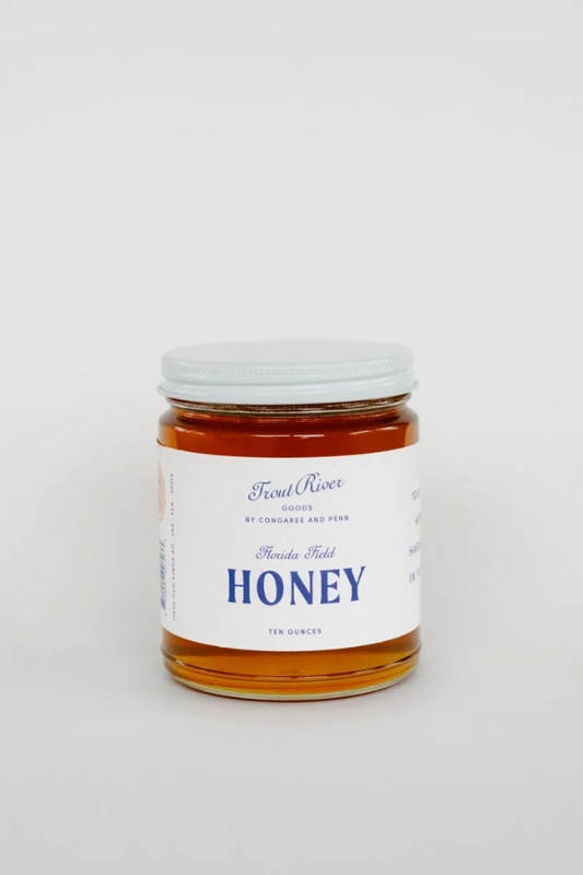 Jar of Congaree and Penn honey preserves with golden honey visible, showcasing the natural, thick preserve texture.