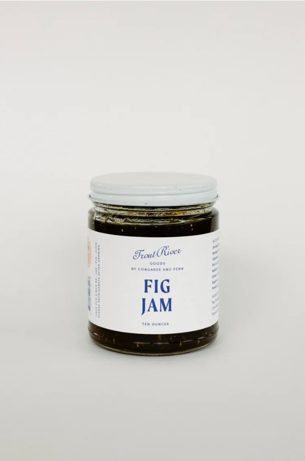 Close-up of Congaree and Penn fig jam preserves jar with golden fig preserves and rustic label, showcasing the product's texture.