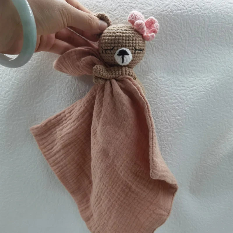Baby bib with sleeping animals and rattle, featuring soft fabric and cute animal designs by Petite Pioneers.