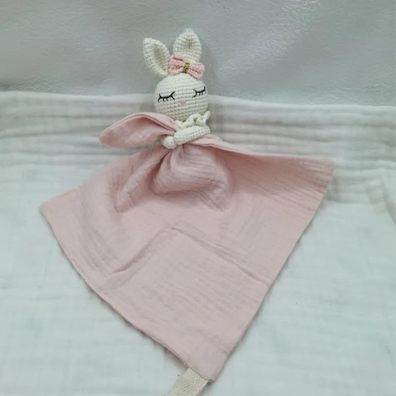 Baby bib with sleeping animal rattle from Petite Pioneers, featuring soft fabric and cute animal design for infants.