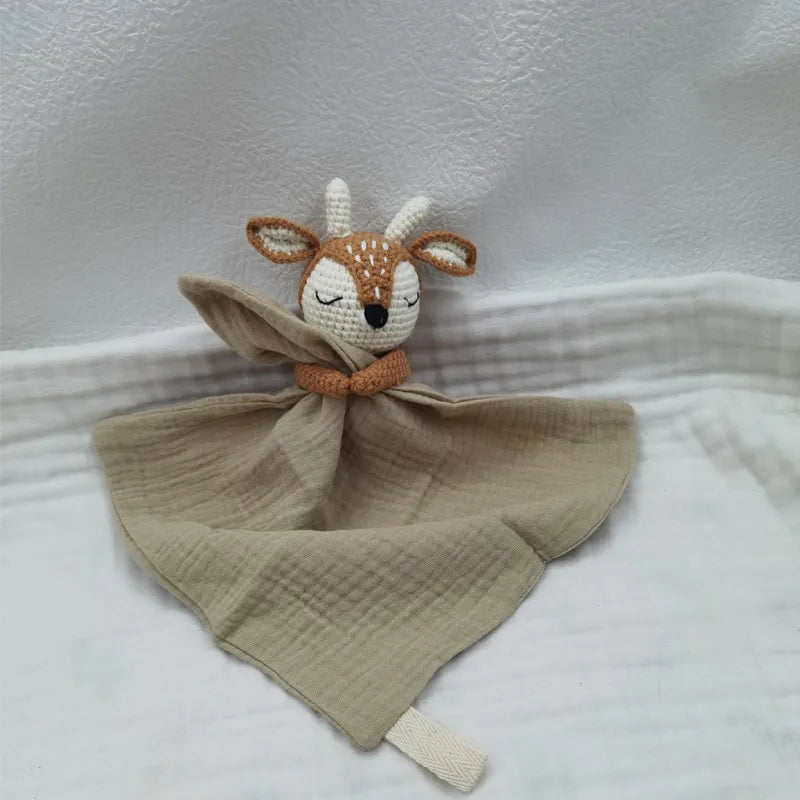 Baby bib with sleeping animal designs and attached rattle from Petite Pioneers, soft fabric and cute animal illustrations.