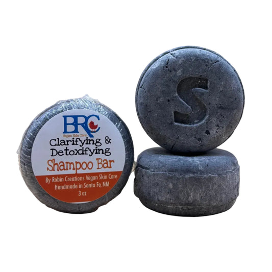 By Robin Creations clarifying and detoxifying shampoo bar with natural ingredients, shown in a sleek packaging.