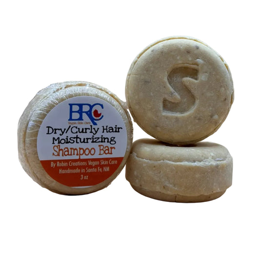 By Robin Creations moisturizing shampoo bar for dry and curly hair, showing the square soap-like shampoo with label detail.