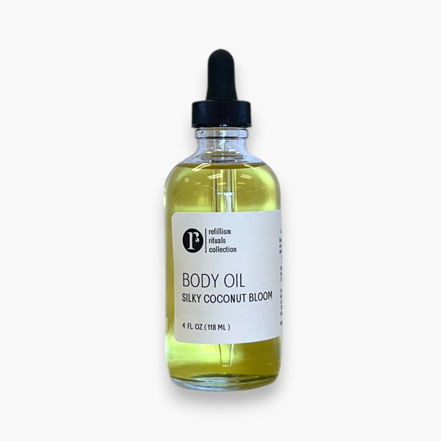 Refillism Silky Coconut Bloom body oil bottle, personal care product with a smooth, silky coconut scent and nourishing formula.