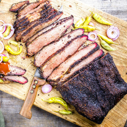 Slow smoked BBQ brisket from Pig of the Month BBQ, sliced and ready to serve, showcasing tender, flavorful smoked meat.