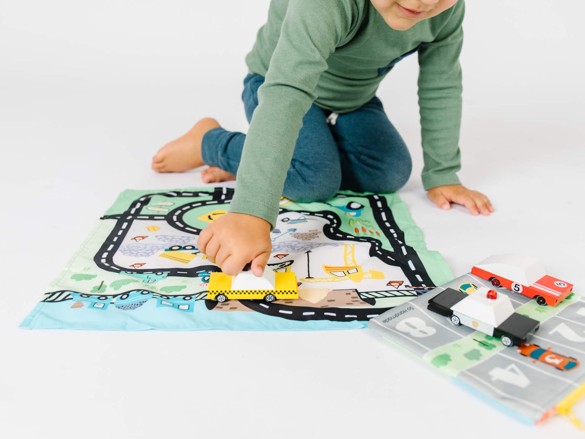 Colorful toy car playmat and storage pouch by So Handmade Shop, featuring roads and cityscape for kids' travel entertainment.