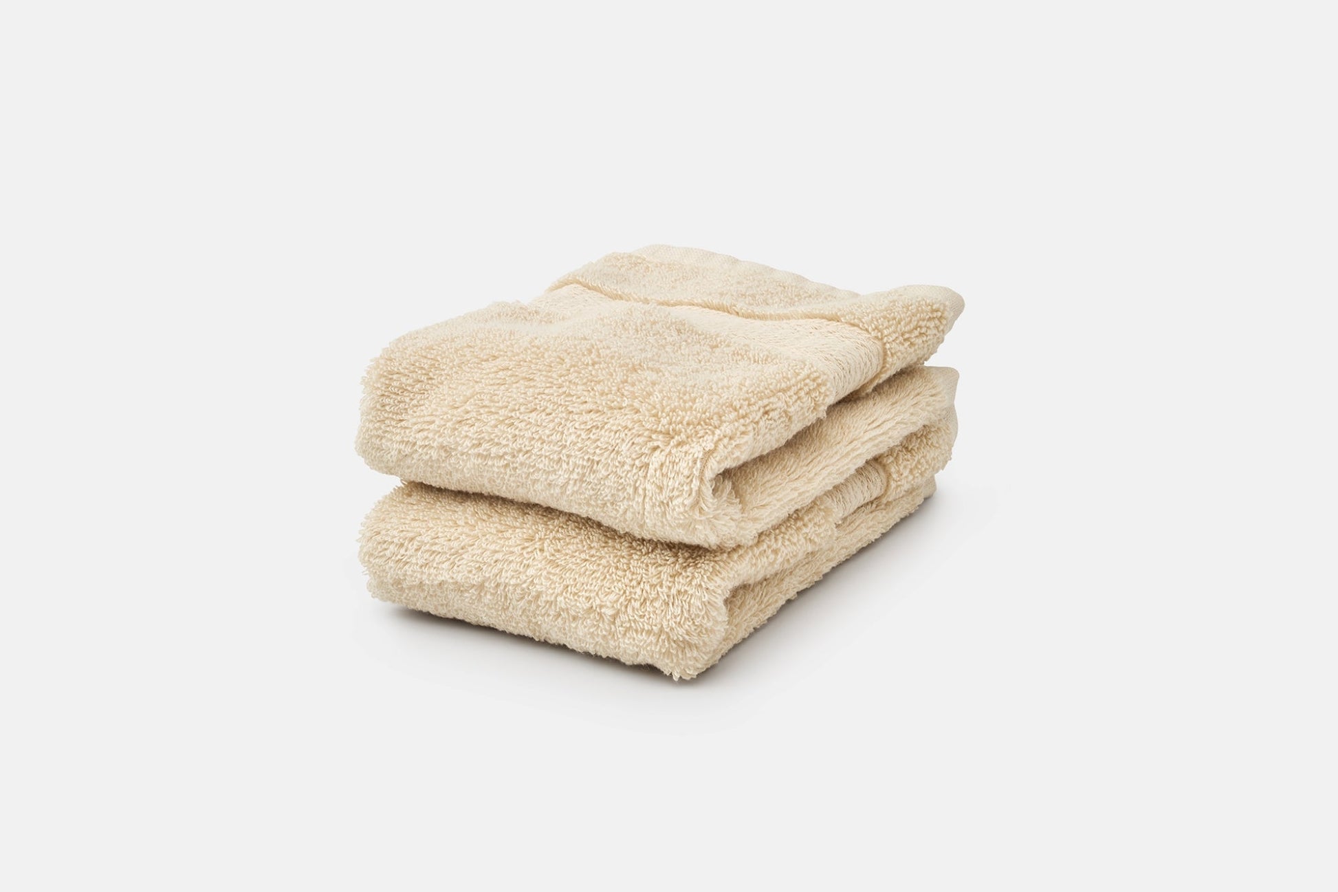 Stack of luxury natural cotton bathroom washcloths by American Blossom Linens in neutral tones for soft, absorbent bath essentials.