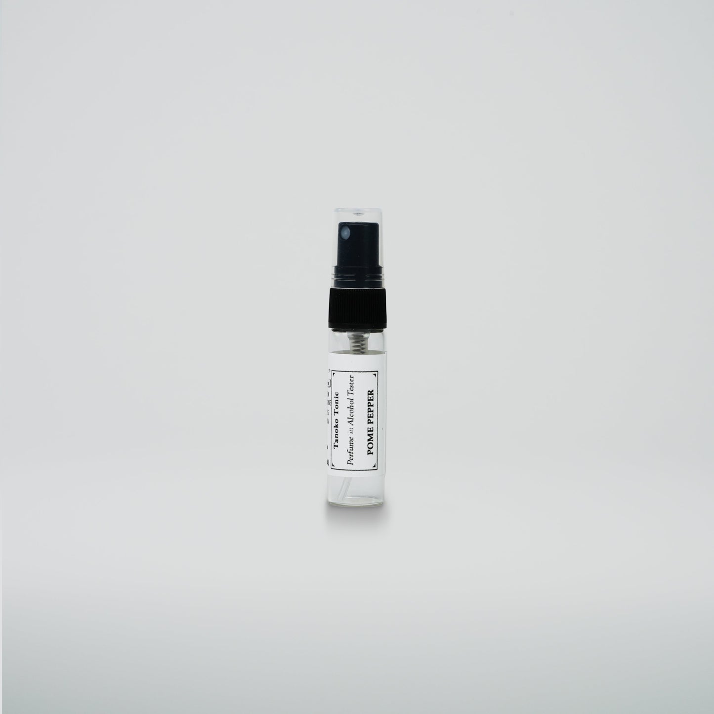A small Rustic Strength perfume sample vial with a black cap and white label stands upright on a plain white background—a perfect addition to the Perfume Sample Pack | One Vial of Each Scent.