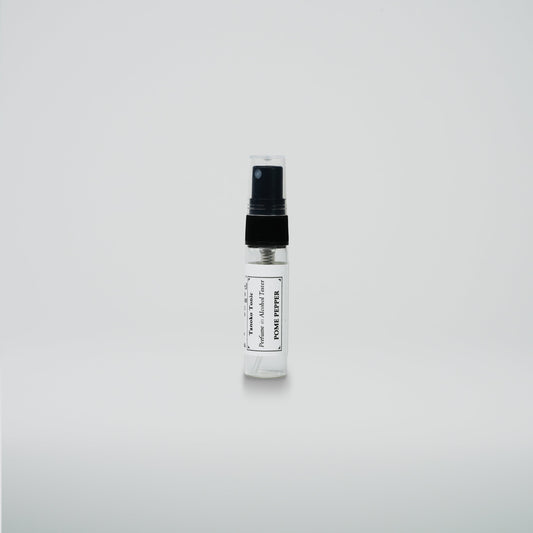 A small Rustic Strength perfume sample vial with a black cap and white label stands upright on a plain white background—a perfect addition to the Perfume Sample Pack | One Vial of Each Scent.