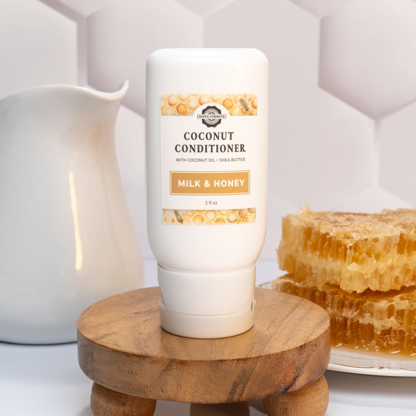 Rustic Strength Milk & Honey travel size bath and body conditioner in a 2 oz bottle, perfect for on-the-go skincare.