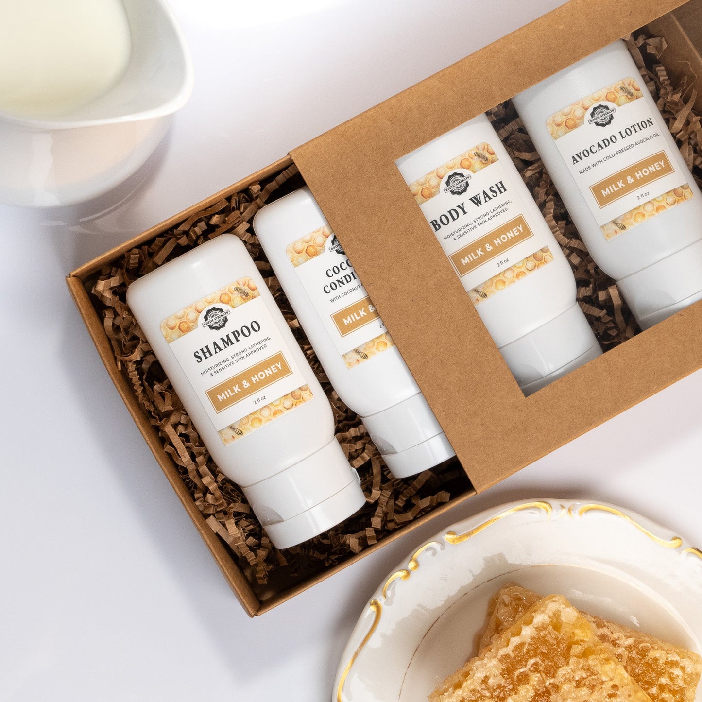 Rustic Strength Milk & Honey travel kit with 2 oz bath and body products, overhead view of the set in a compact travel size.