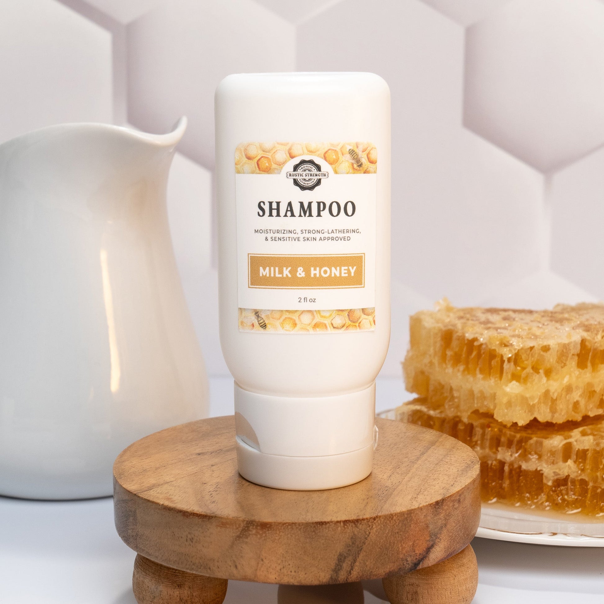 Rustic Strength Milk & Honey travel-sized bath and body kit with 2 oz shampoo bottle, natural ingredients for skincare.