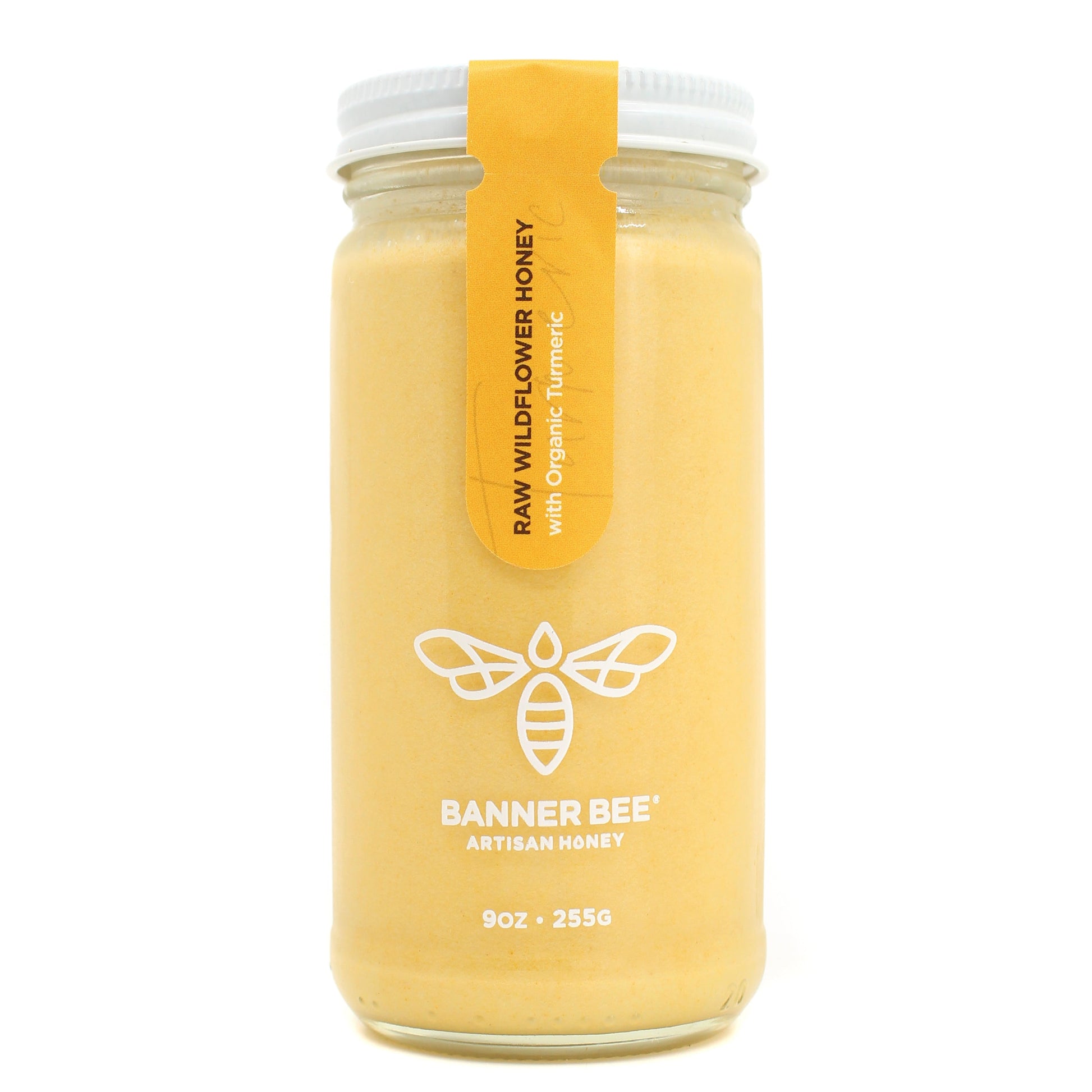 Jar of turmeric enriched raw honey from BannerBee Company LLC, showing golden honey infused with turmeric roots.