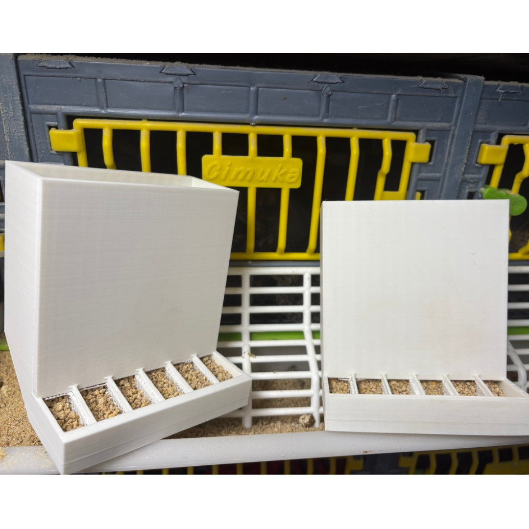 Pair of Quailz.com front-slot feeders with adjustable spill-resistant design for Hatching Time Chimuka Cage Systems, made in USA