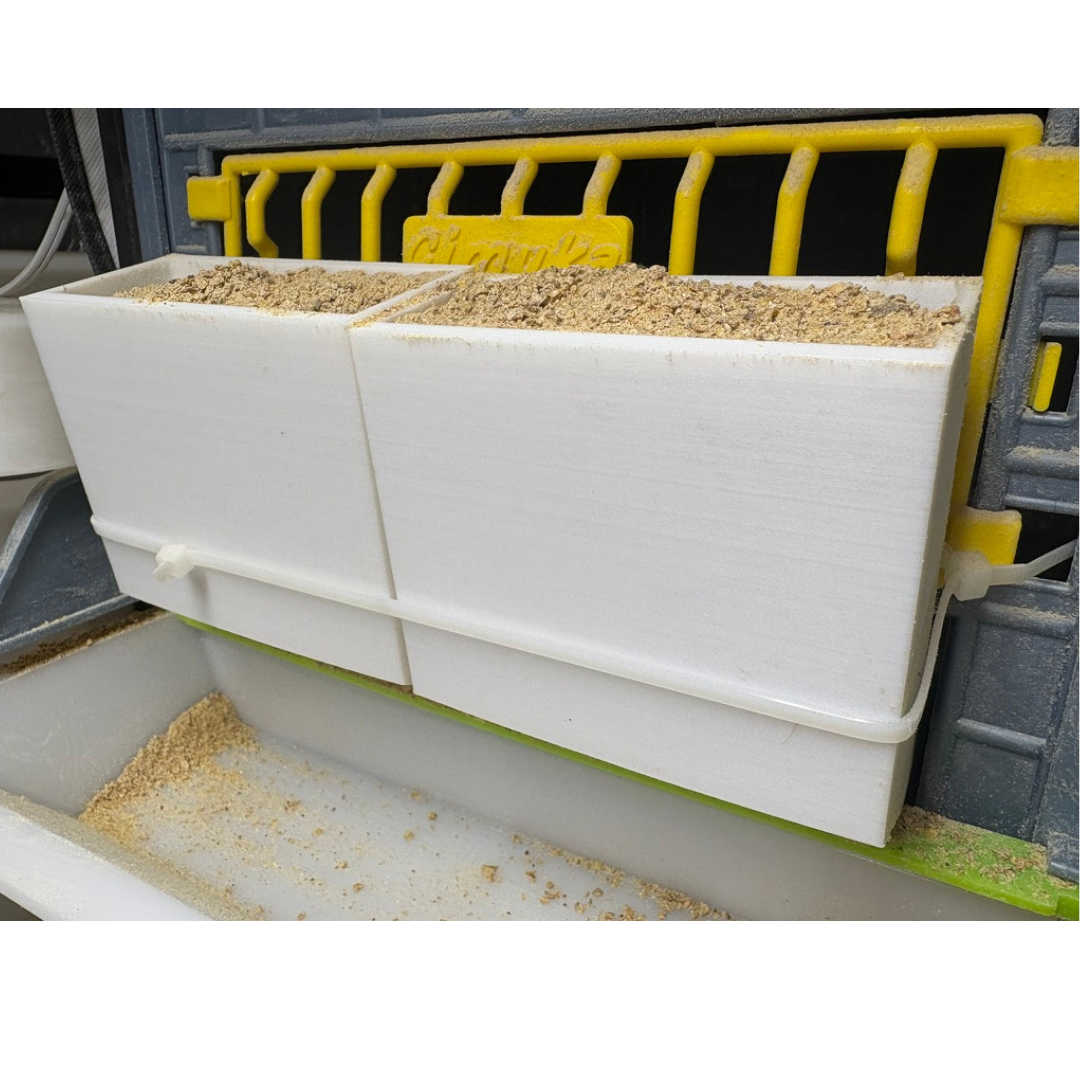 Pair of Quailz.com front-slot feeders with adjustable spill-resistant design for hatching time quail cage systems.