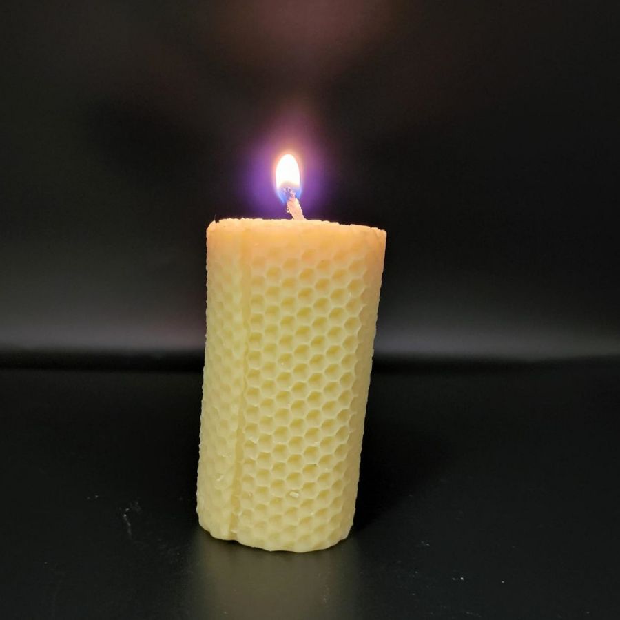 Beeswax honeycomb candle in a 6 oz size, natural honey color, with textured honeycomb pattern, from Buzz Savories.