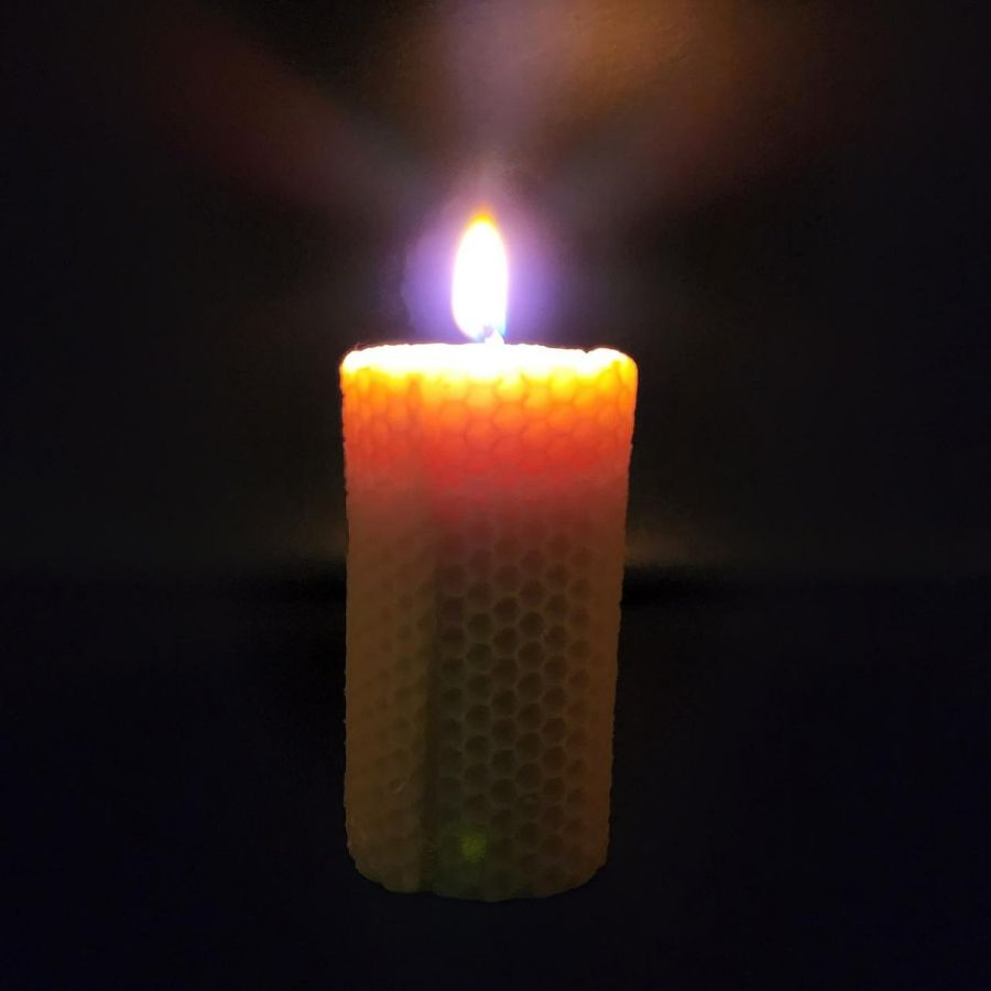 Beeswax honeycomb candle in a 6 oz jar, natural honey-colored wax with visible honeycomb pattern, from Buzz Savories, LLC.